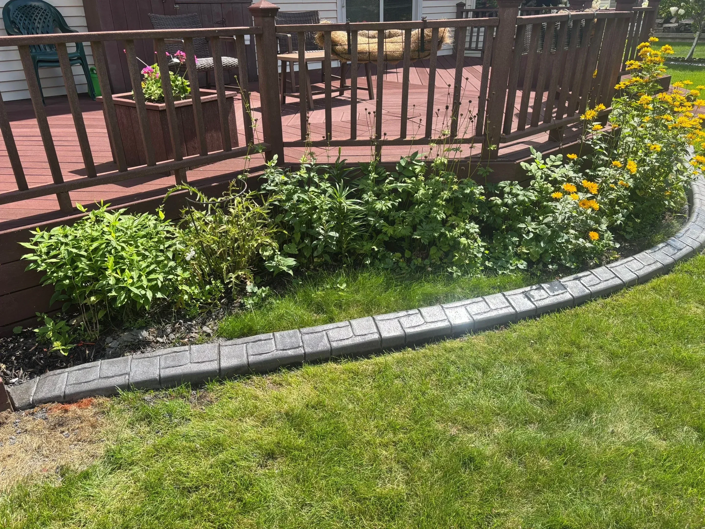 Curved mower curbing around landscape feature